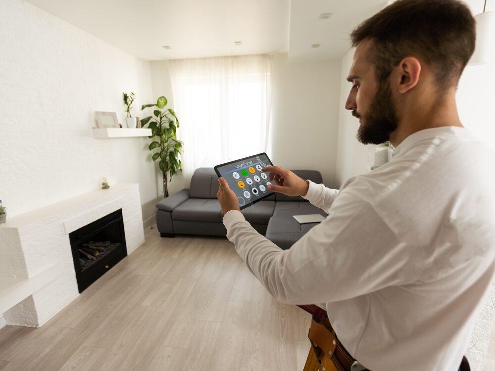 A homeowner using a smart home app in a living room