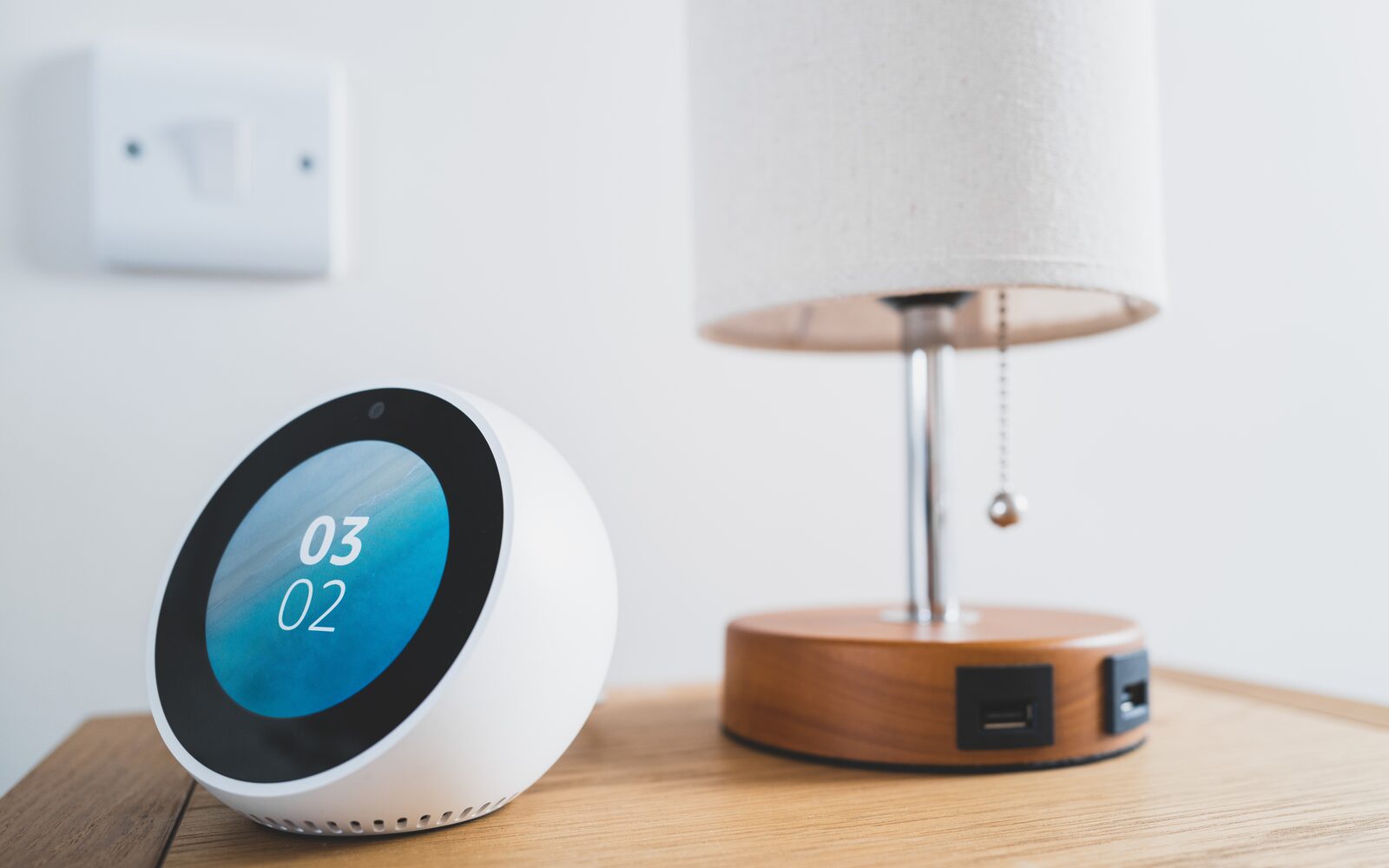 A homeowner controlling smart home devices from a phone in a hallway
