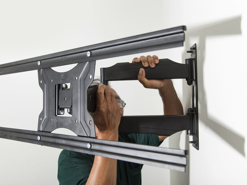 An articulating TV wall mount fitted to a wall